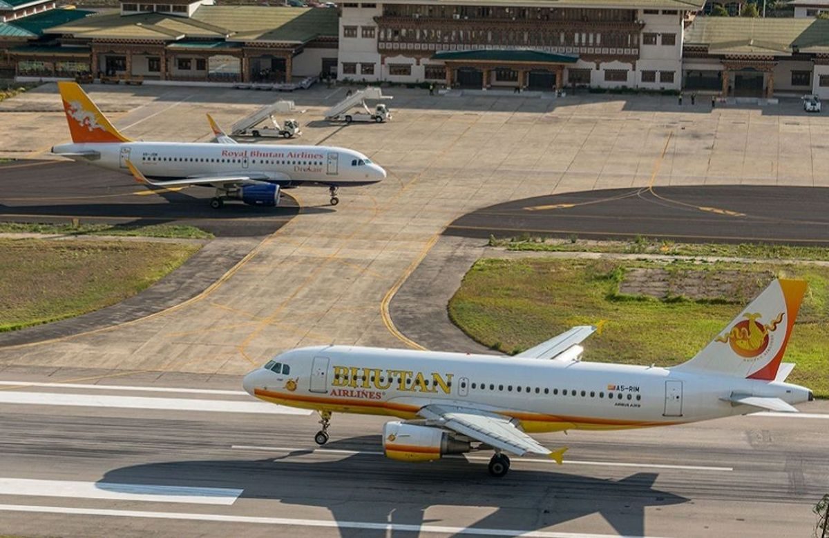 Aircraft on the apron at Paro International Airport, ringed by mountains